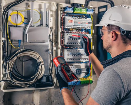 man-electrical-technician-working-switchboard-with-fuses_169016-24062 man-electrical-technician-working-switchboard-with-fuses_169016-24062